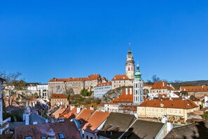 A historic town with a prominent tower and various buildings with red-tiled roofs. - Pension Nostalgie - Minihotel (Cesky Krumlov)