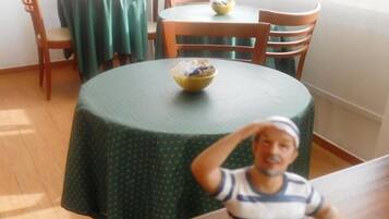 Enjoy meals in this cozy dining area with a round table and comfortable seating for two.