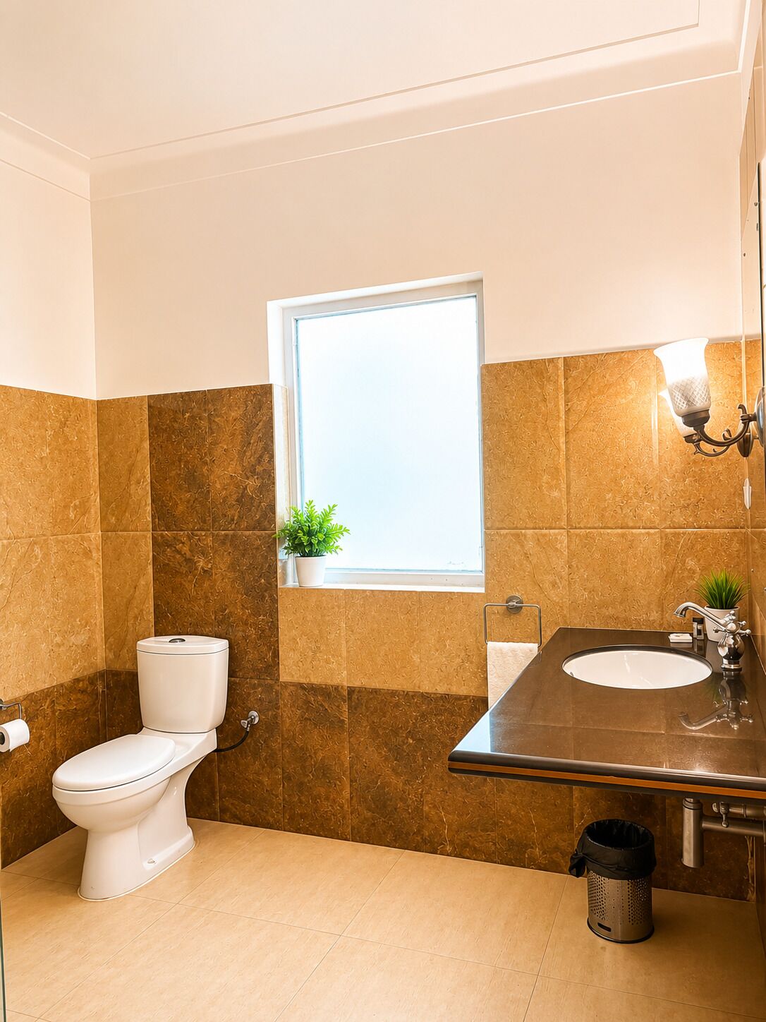 A bathroom with a toilet, sink, and window.