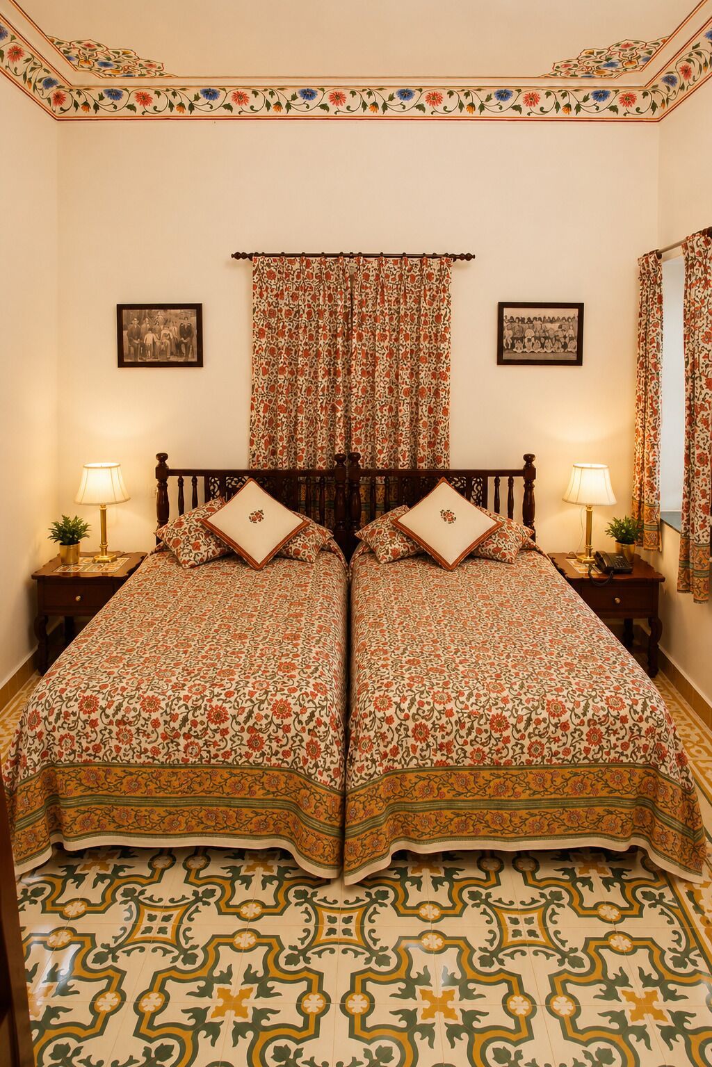 A double bed with floral-patterned bedding, two bedside tables with lamps, a patterned floor, and a floral curtain.