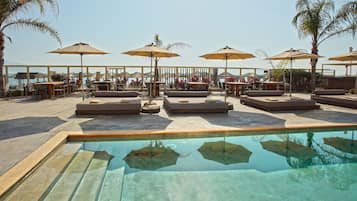 Seasonal outdoor pool, pool umbrellas, pool loungers