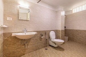 A bathroom with a sink, toilet, and shower.