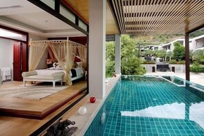 A bedroom with a canopy bed, a small pool, and a view of a resort area. - Club Wyndham Patong Hill Phuket, Trademark Collection by Wyndham (Patong)