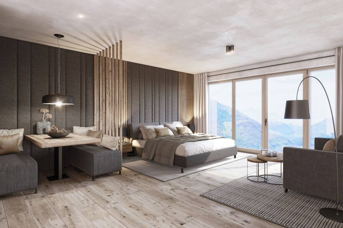 A modern bedroom with a large bed, a desk, and a sofa.