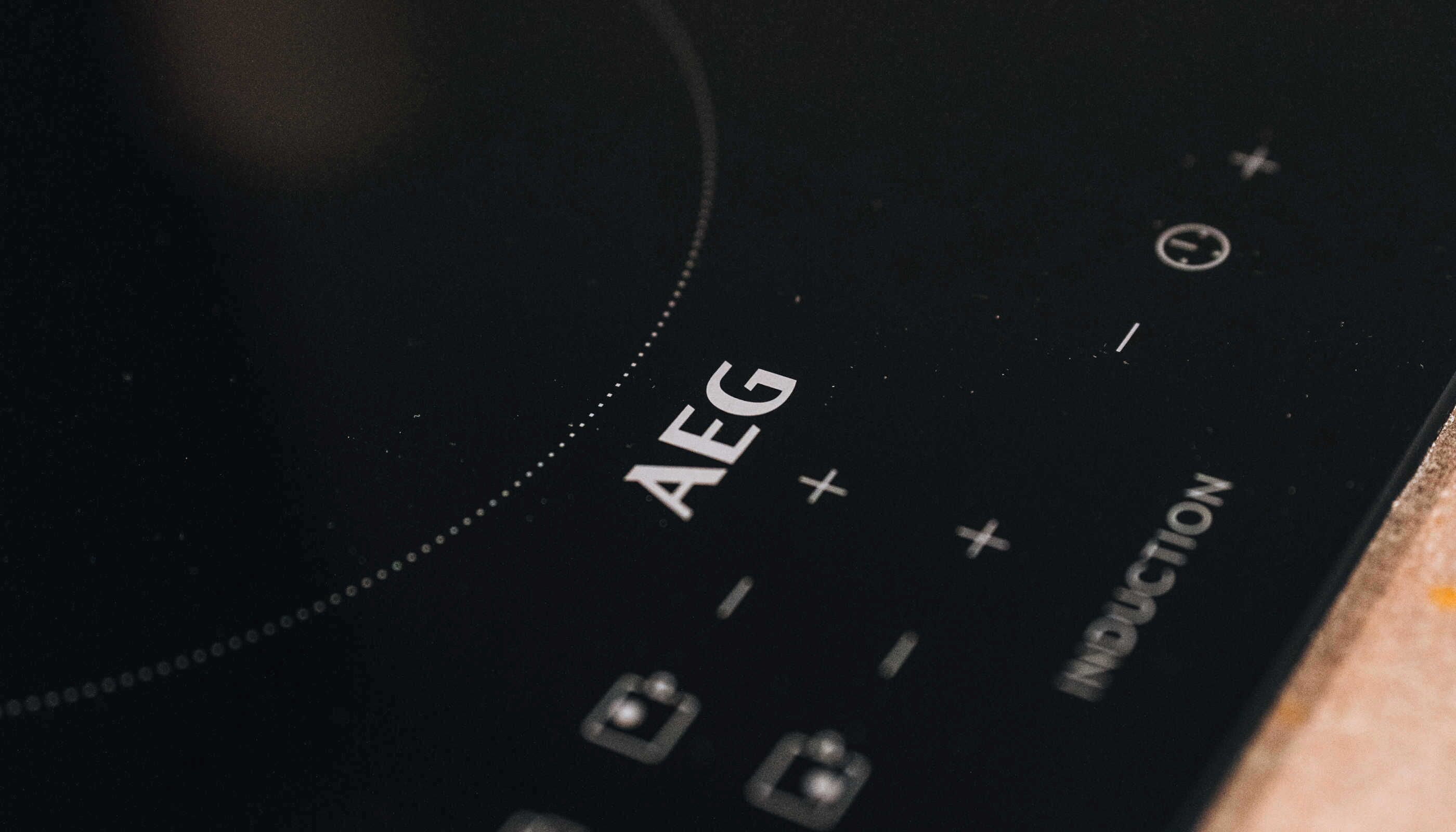 A close-up of a control panel with the label "AEG" and various symbols, likely indicating settings or functions.