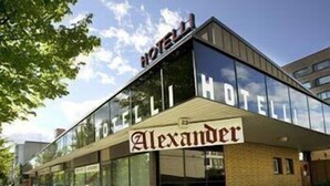 A modern hotel with a prominent 'Alexander' sign, large glass windows, and a brick facade. - Hotel Alexander (Maenttae-Vilppula)