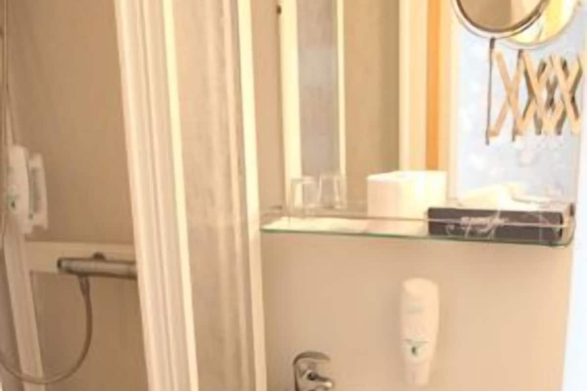 A bathroom with a shower, sink, and toilet.