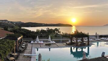 Seasonal outdoor pool, open 7:00 AM to 8:00 PM, pool umbrellas