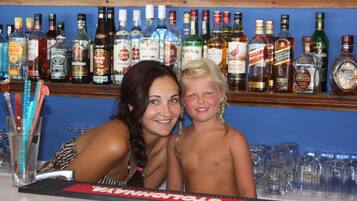A bar with a variety of liquor bottles on shelves.