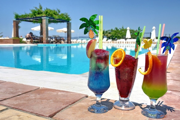 Seasonal outdoor pool, open 7:00 AM to 8:00 PM, pool umbrellas