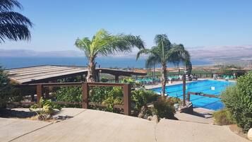 Seasonal outdoor pool, open 9 AM to 6 PM, pool umbrellas, pool loungers