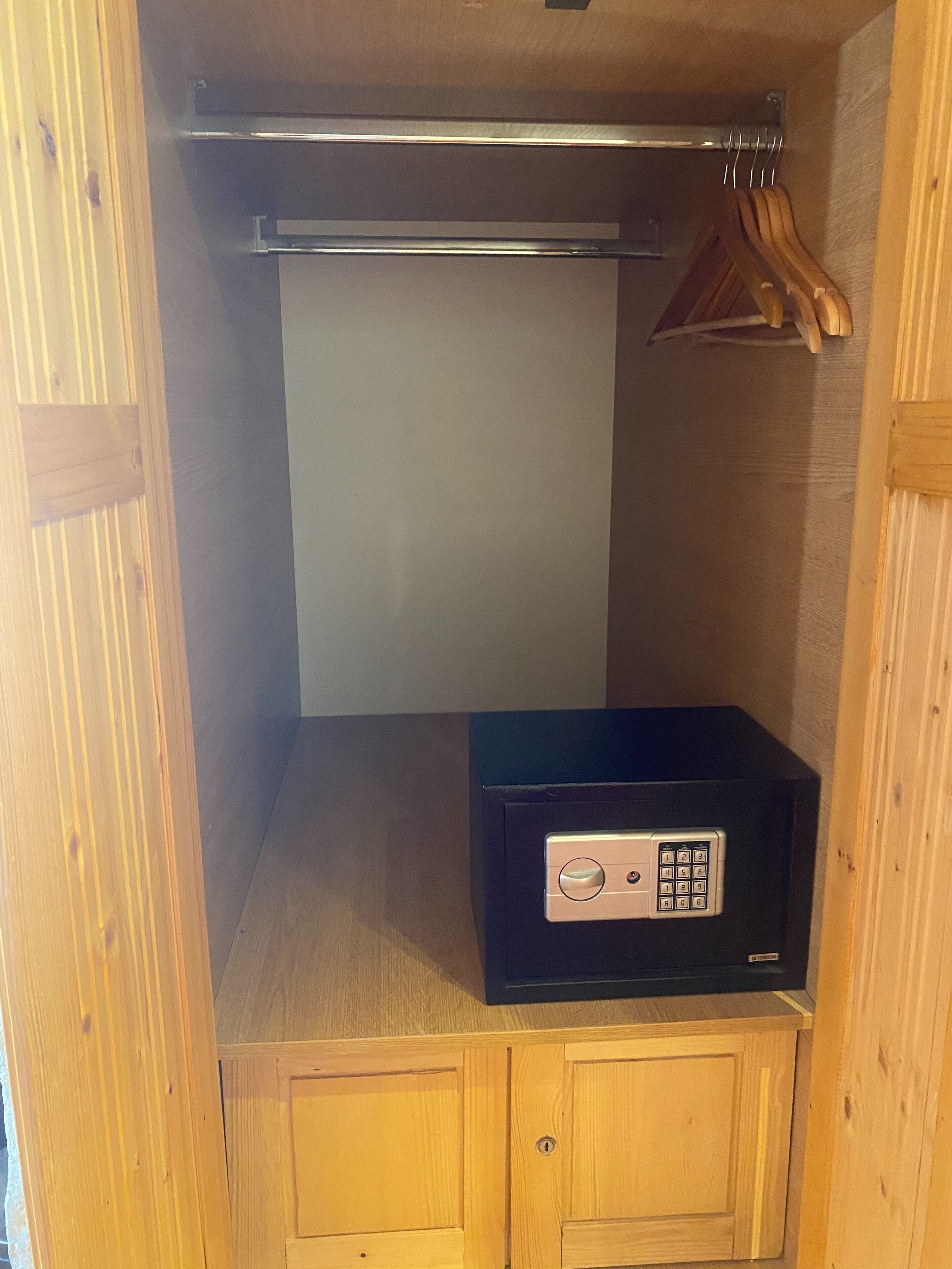 A compact storage unit with a lock and a small control panel, likely for a safe or secure storage.