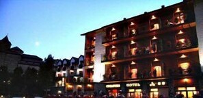 A hotel with multiple floors and balconies, featuring a traditional architectural style with visible windows and a sign indicating it is a hotel. - Edelweiss Hotel (Torla)