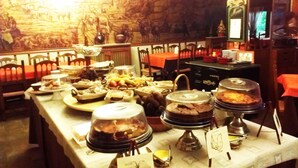 Une table de buffet garnie de divers plats et une fresque murale.