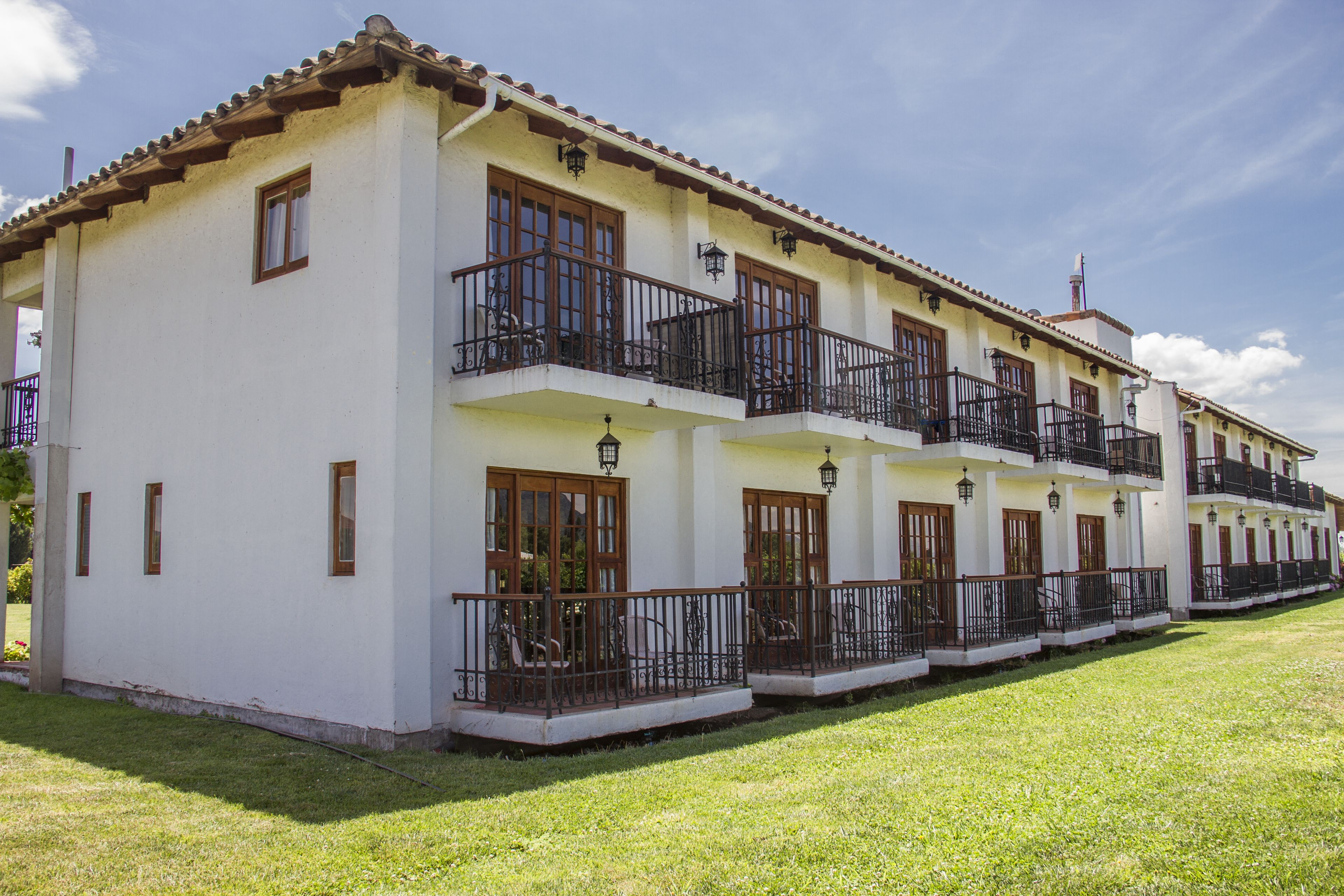 A two-story building with balconies and windows.