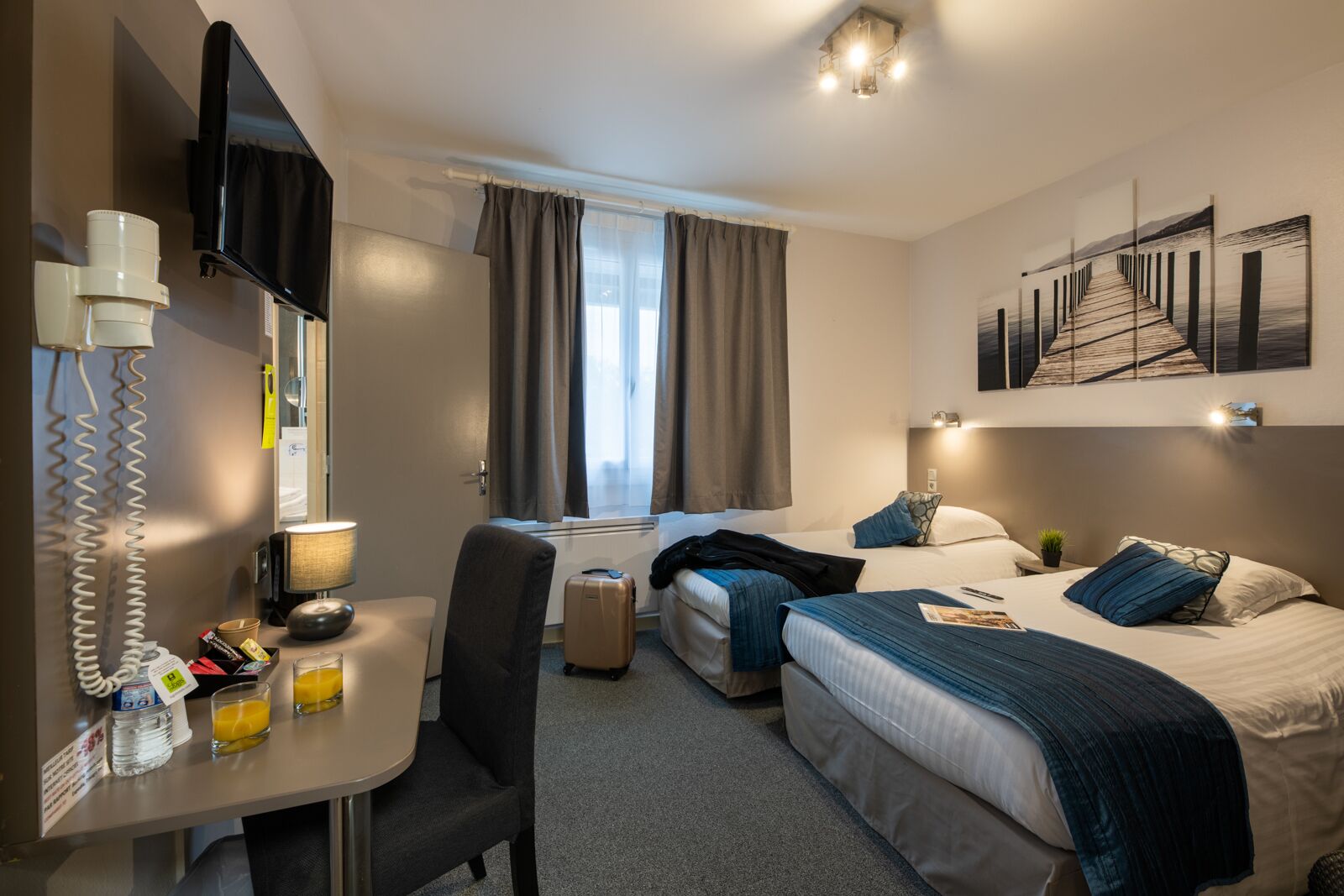 comfort room, 2 single beds | desk, blackout curtains, iron/ironing board, free cots/infant beds