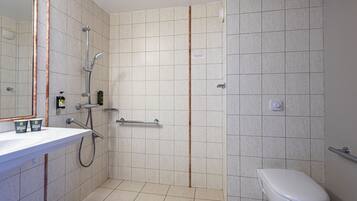 A bathroom with a shower, toilet, and sink.