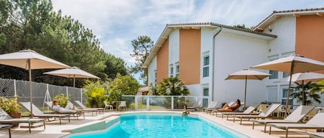 Seasonal outdoor pool, open 9:00 AM to 9:00 PM, pool umbrellas