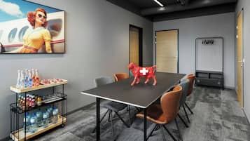 A conference room with a table, chairs, a water dispenser, and a red horse sculpture.