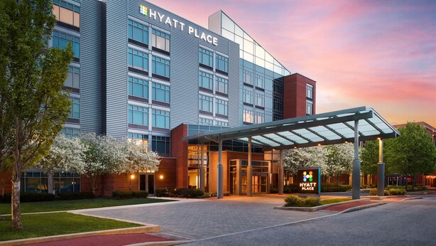 A modern hotel building with a glass facade, a covered entrance, and a sign indicating it's a Hyatt Place. - Hyatt Place Columbus/OSU (Columbus)