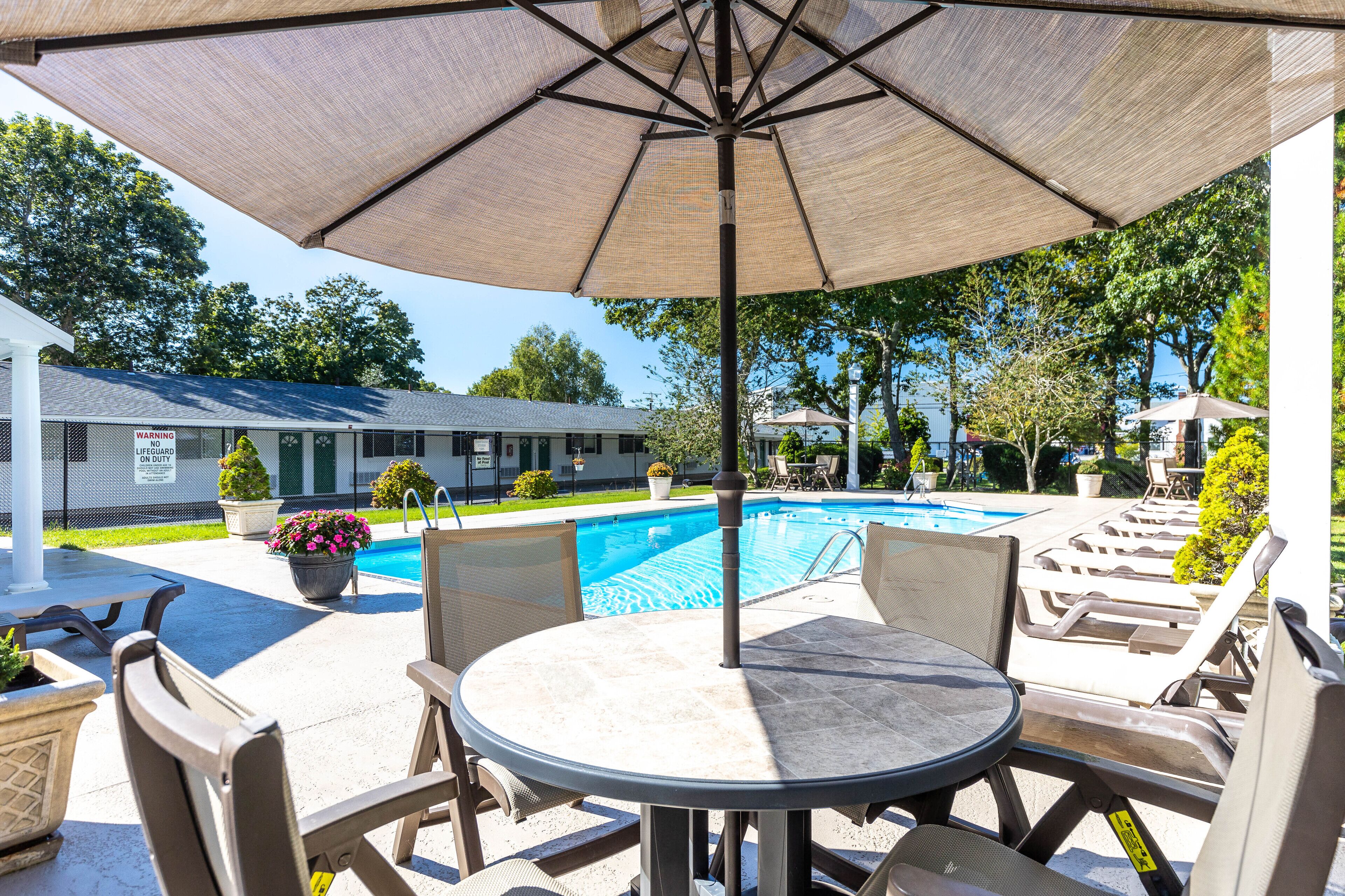 seasonal outdoor pool, open 9:00 am to 8:00 pm, pool umbrellas