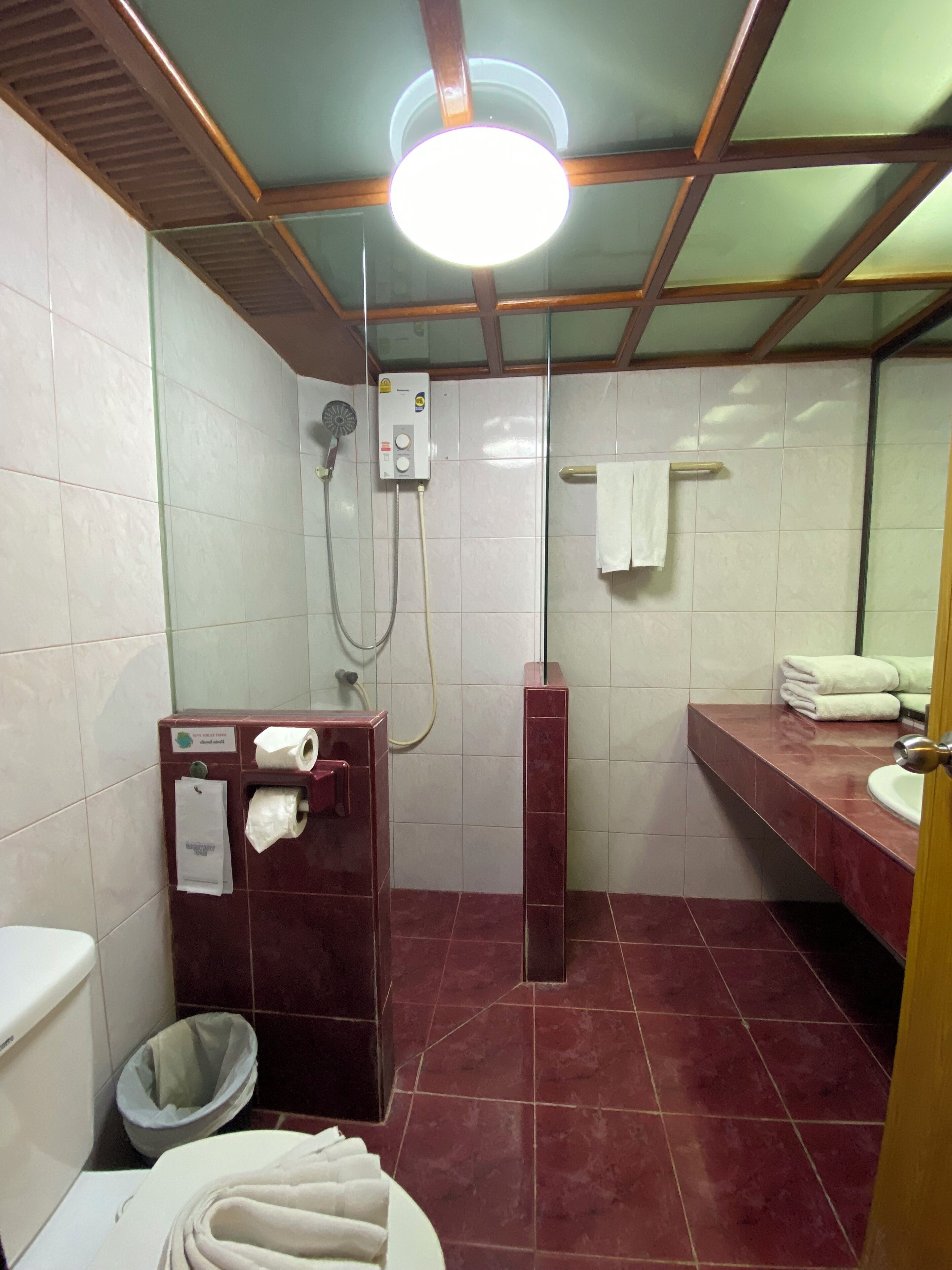 A bathroom with a shower, toilet, and sink.