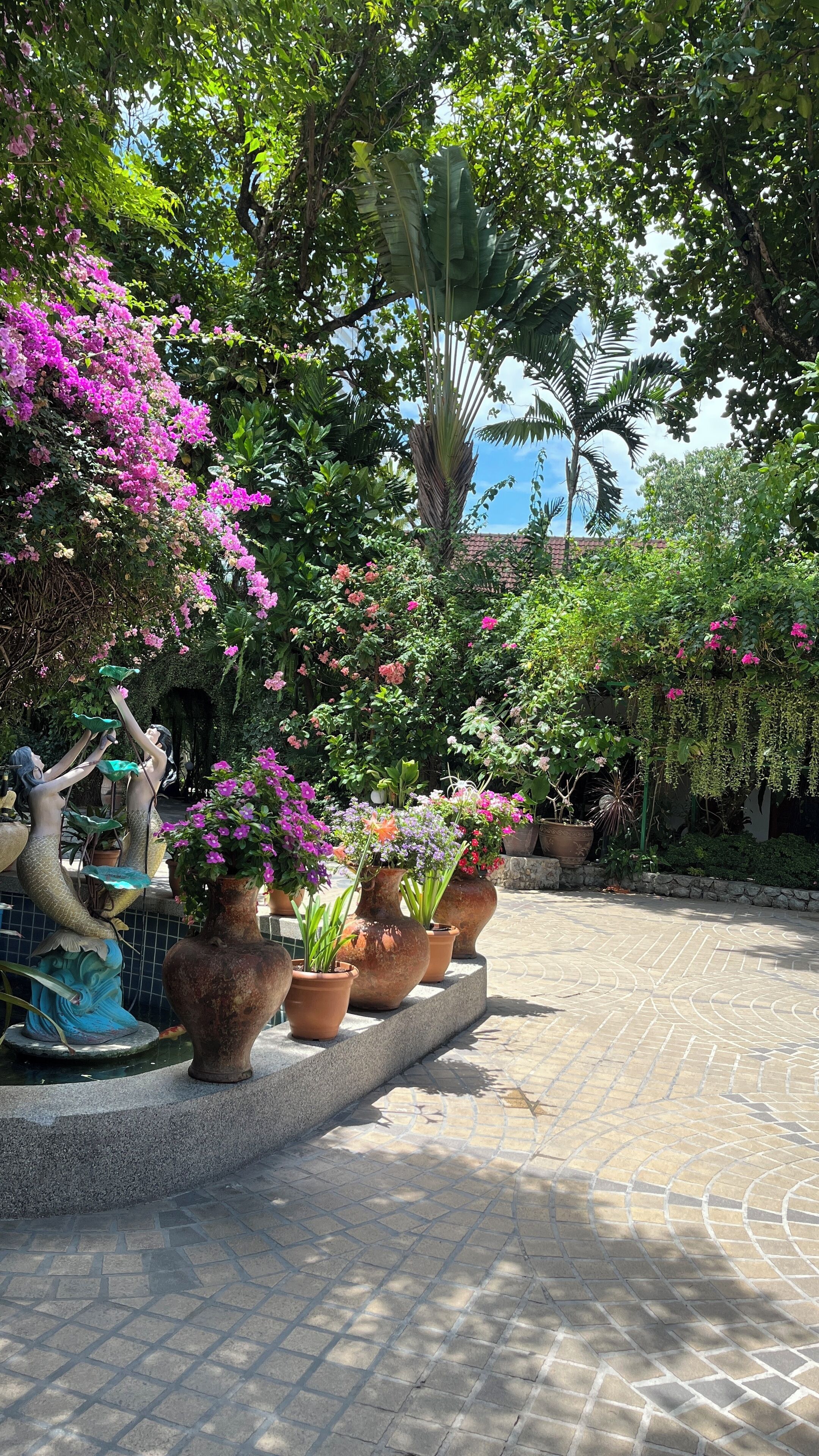 A garden with potted plants and a statue.
