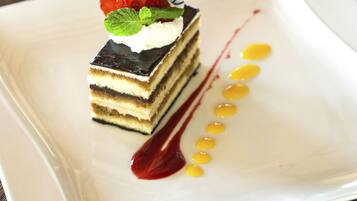 A dessert on a white square plate with a wooden table background.