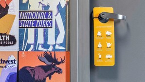 A door with a yellow keycard holder displaying hotel services. - hotelF1 Nemours (Nemours)