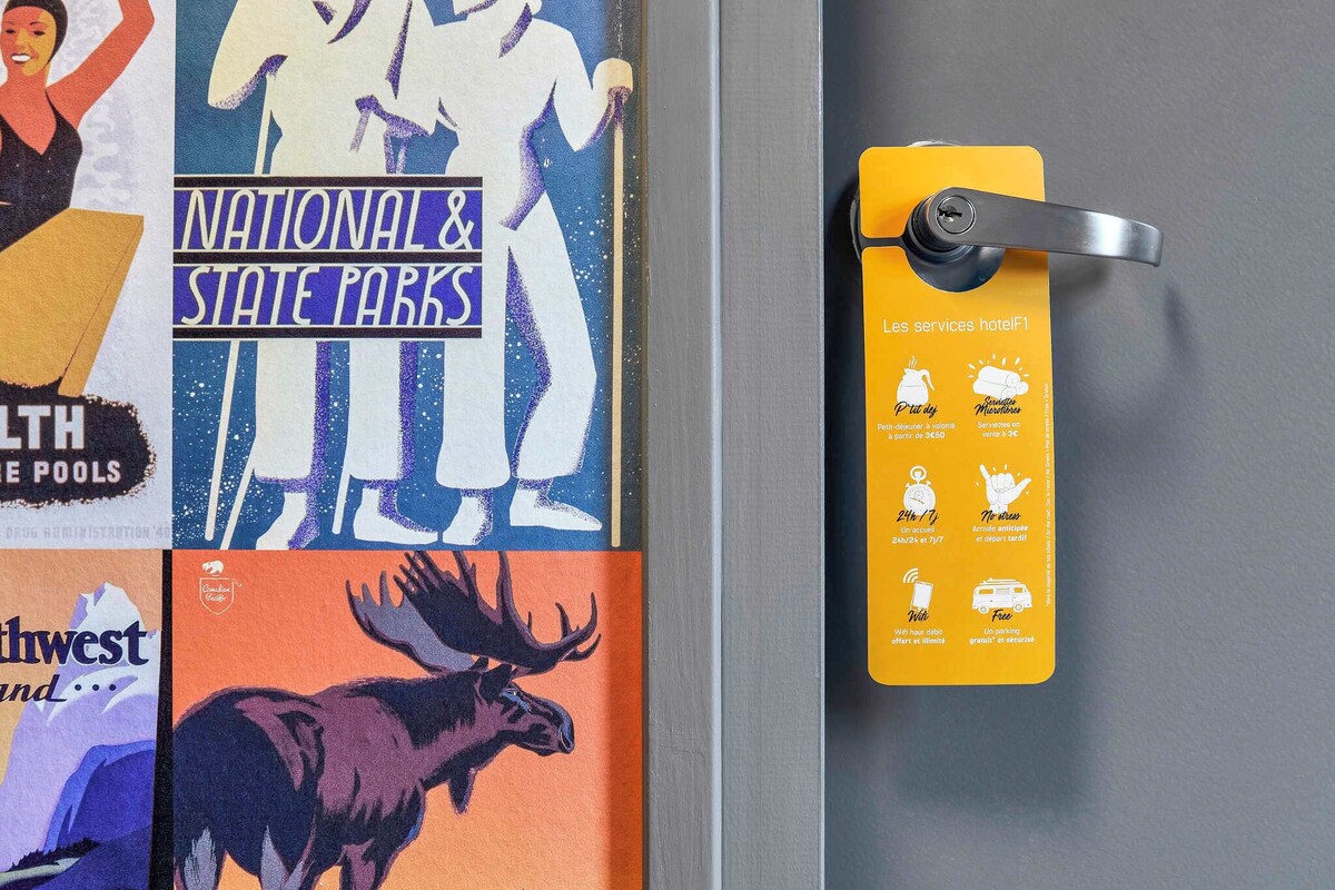 A door with a yellow keycard holder displaying hotel services.