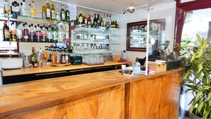 A bar area with shelves of various liquor bottles and glasses. - Hôtel du Parc (Limoges)