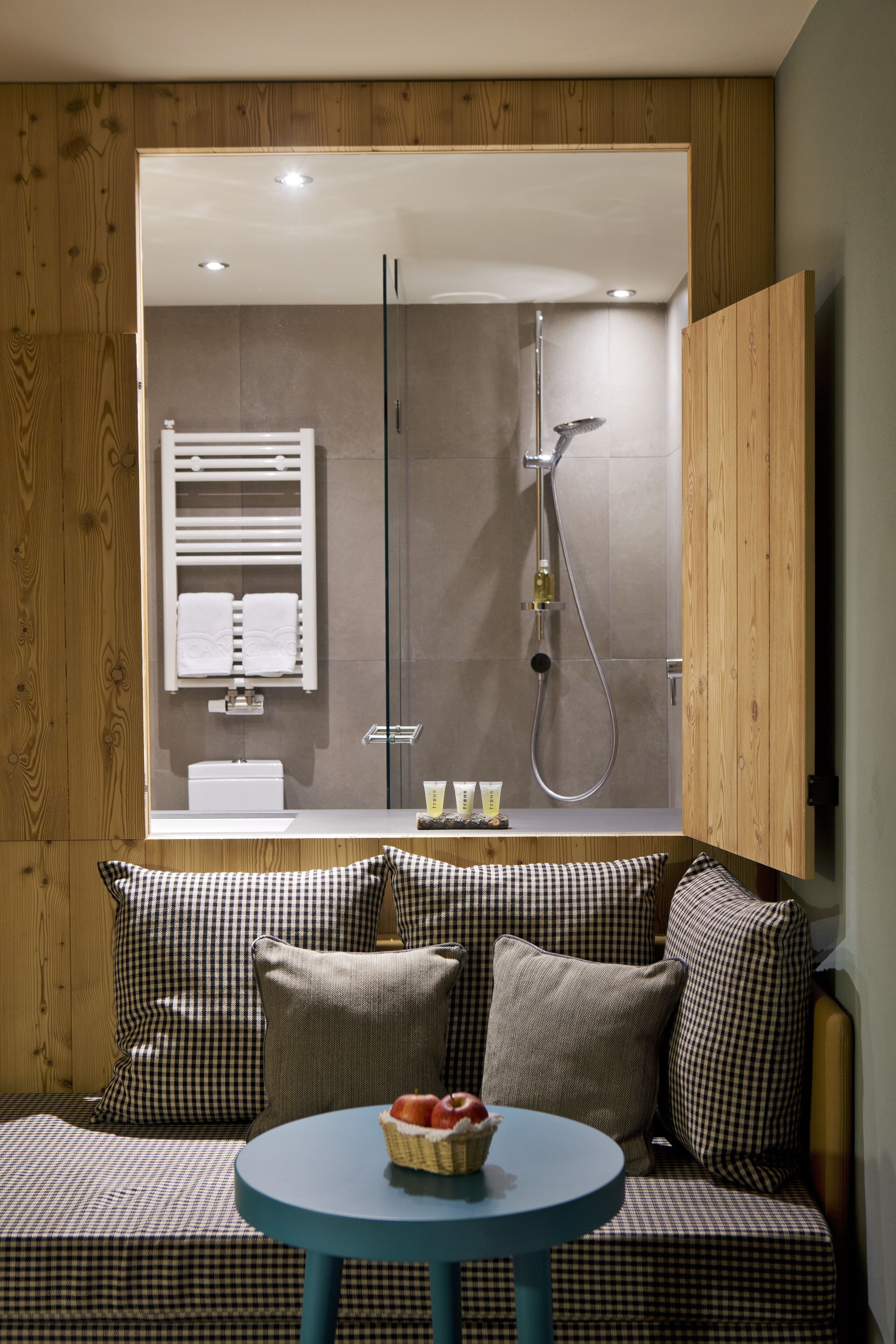 A modern bathroom with a shower, towel rack, and a visible toilet.