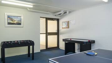 Enjoy games and entertainment in this room featuring a foosball table and ping pong table.