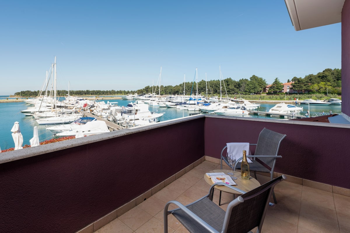 A balcony with a view of a marina.