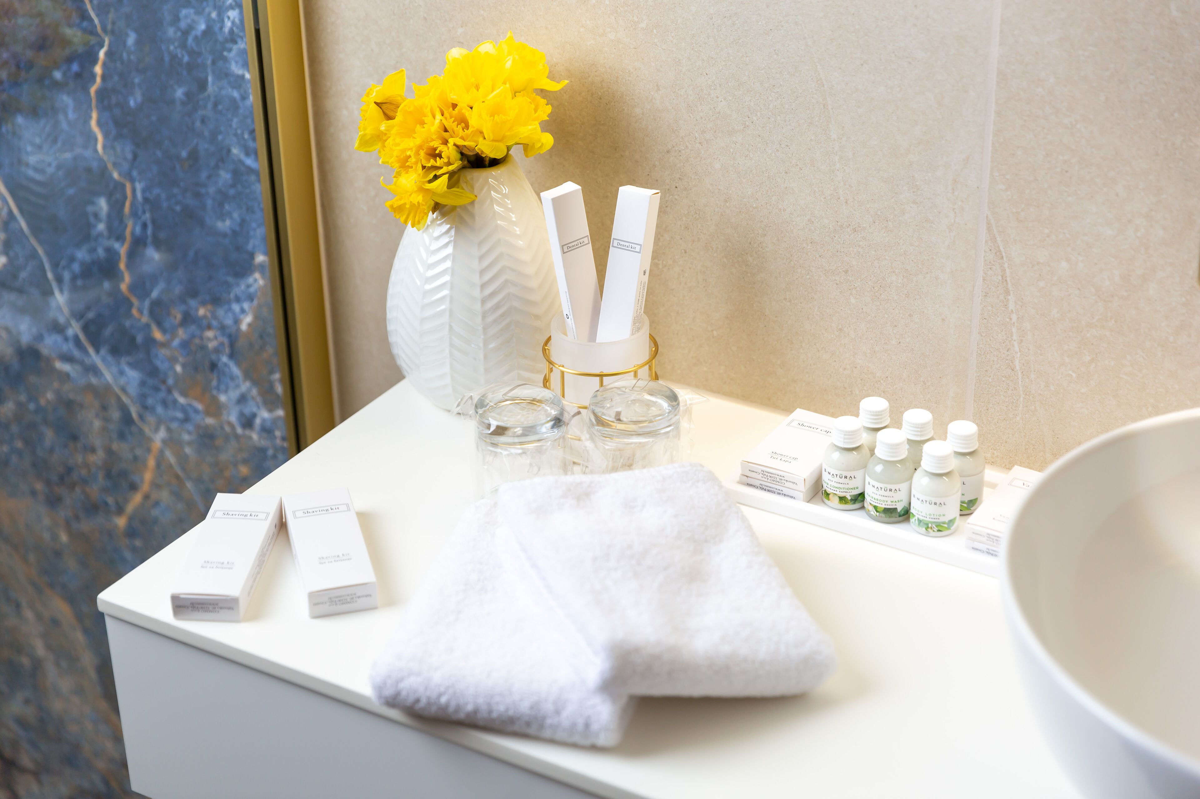 eco-friendly toiletries, hair dryer, slippers, towels