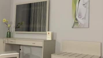 A modern room with a desk, a bench, a large mirror, and a wall-mounted artwork.
