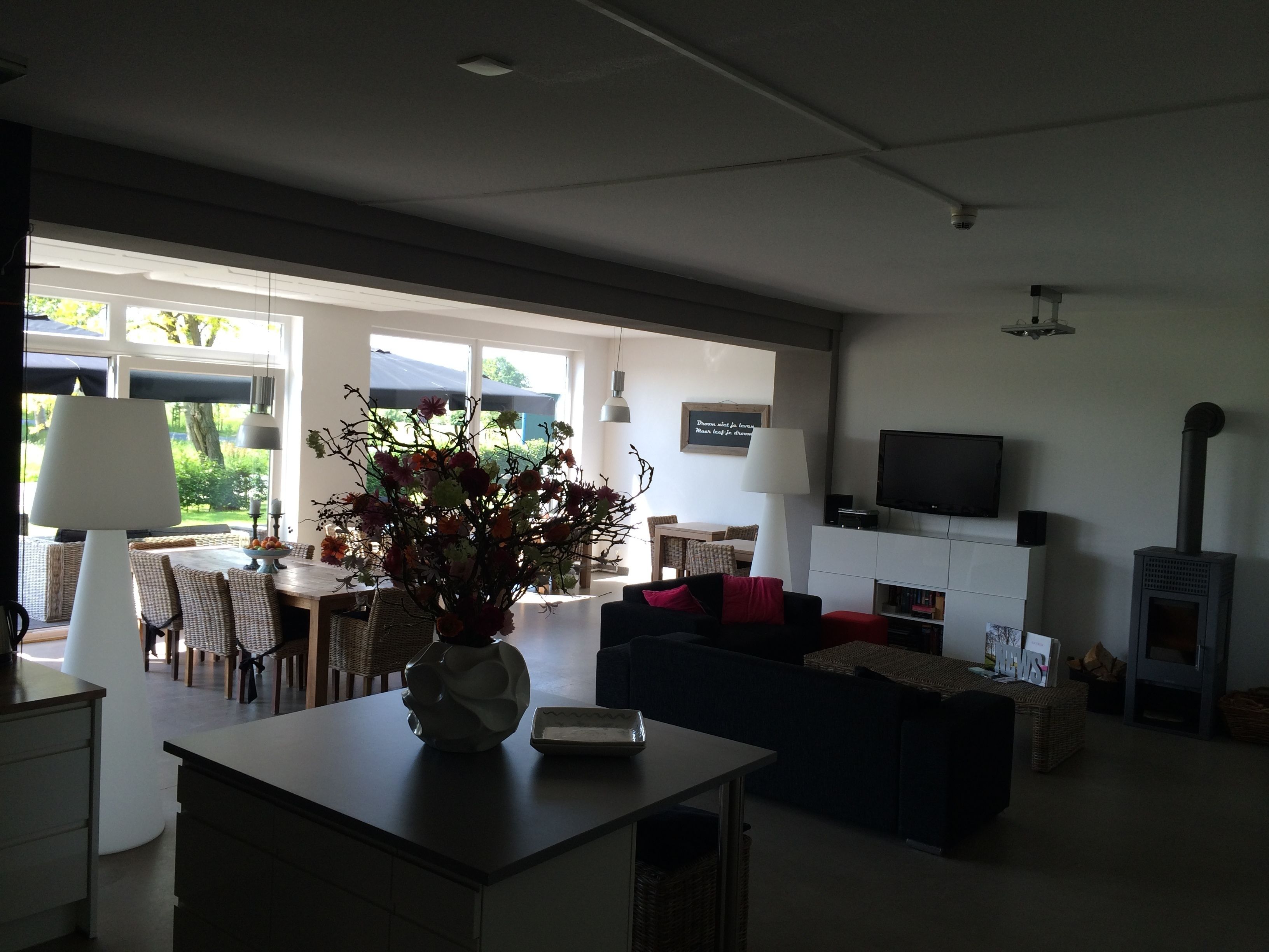 A modern living room with a sofa, a coffee table, a TV, and a fireplace.