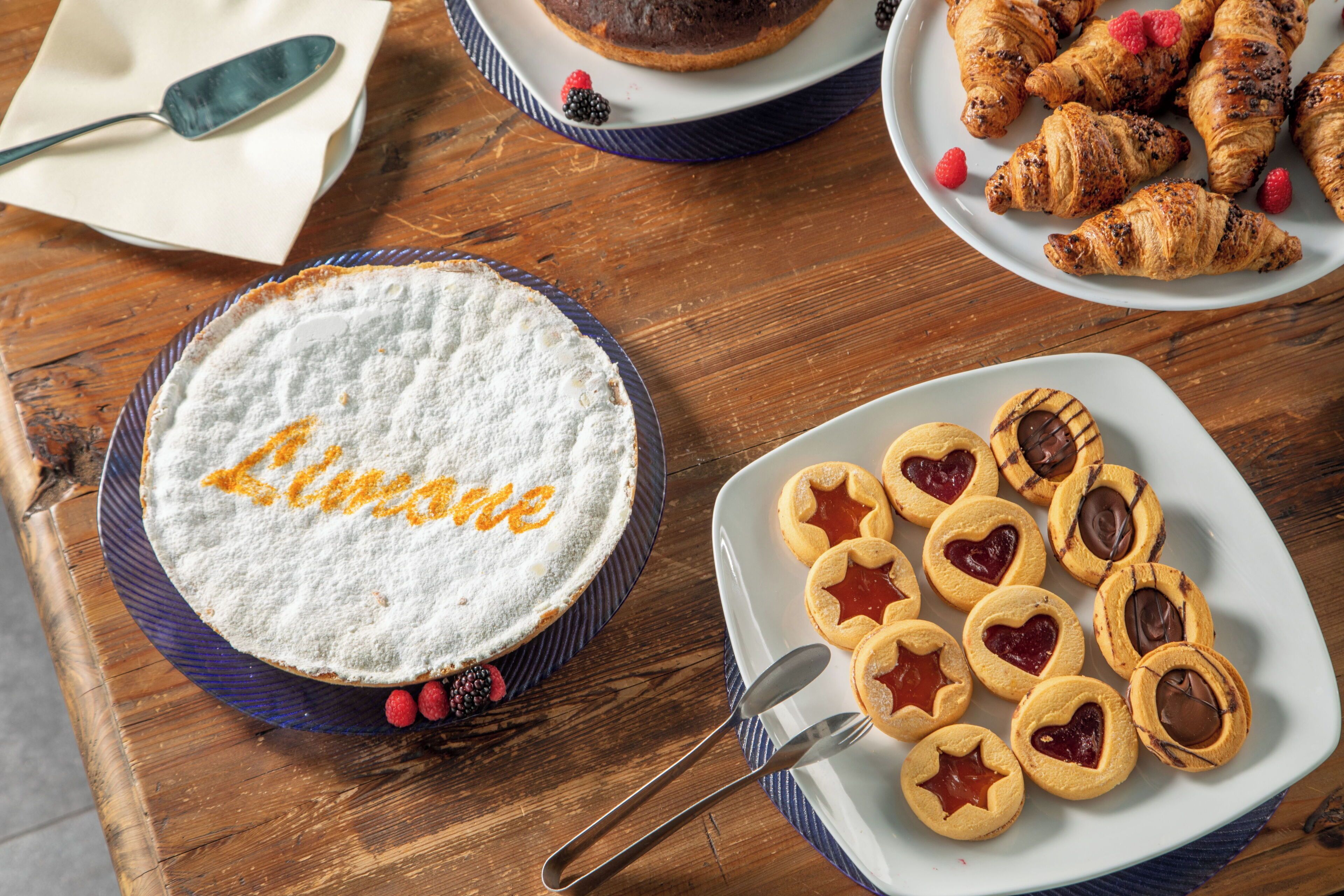 A dessert table with a cake, cookies, and pastries.