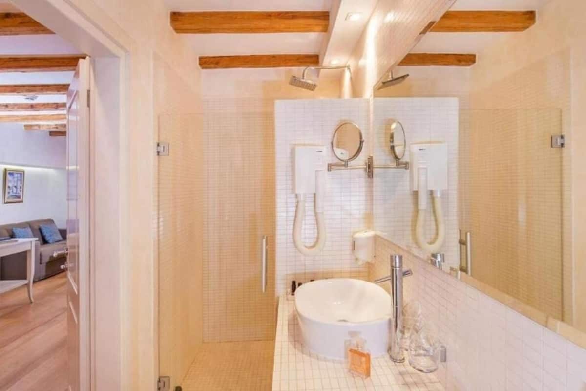 junior studio suite | bathroom | shower, rainfall showerhead, free toiletries, hair dryer