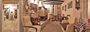Relax in a traditional space with a cozy seating area, wooden coffee table, and stone fireplace.