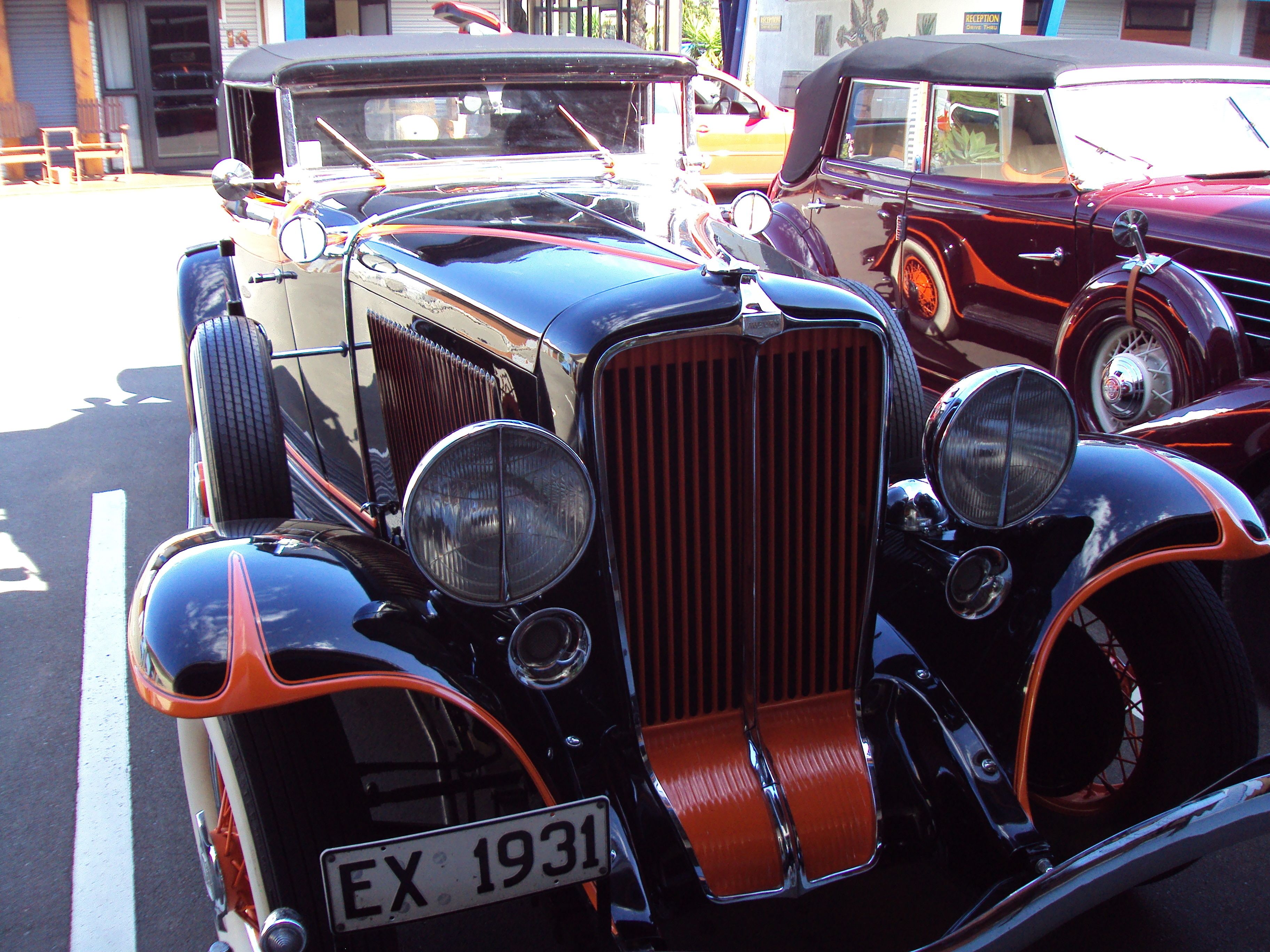 A vintage car with a license plate EX 1931.