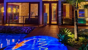 A modern building with a wooden roof, a swimming pool with a koi fish design, and a sign reading "WELLS & SPA". - The Westin Porto de Galinhas, an All-Inclusive Resort (Ipojuca)