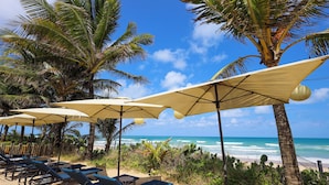 A beachside lounge area with sun umbrellas and lounge chairs, overlooking the ocean. - The Westin Porto de Galinhas, an All-Inclusive Resort (Ipojuca)