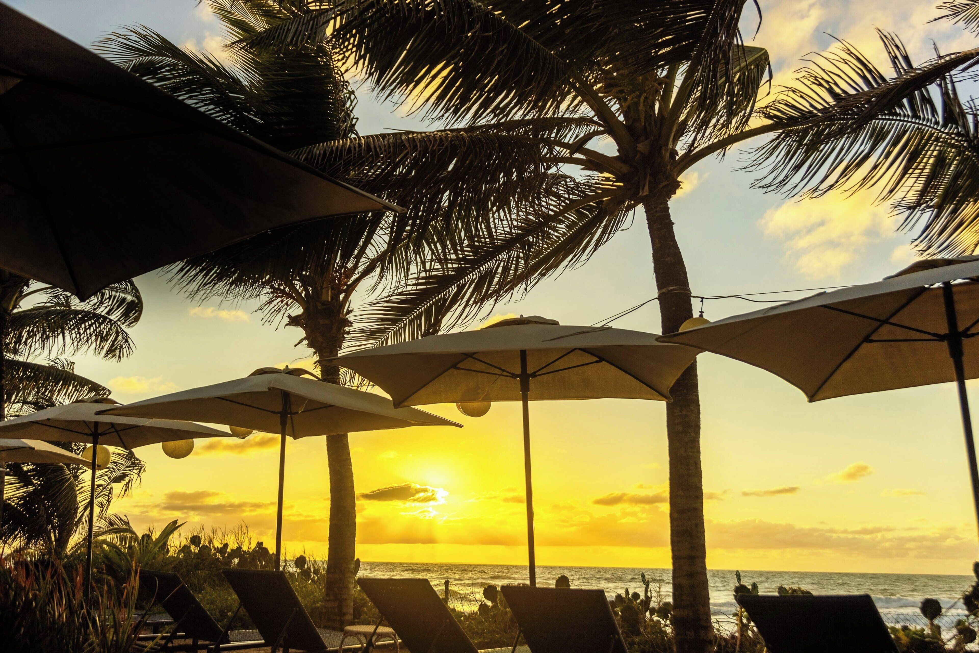 On the beach, white sand, sun-loungers, beach umbrellas