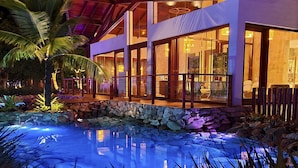 A modern house with large windows, a stone wall, and a swimming pool. - The Westin Porto de Galinhas, an All-Inclusive Resort (Ipojuca)