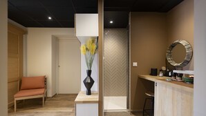 Une salle de bain moderne avec une douche, un lavabo et un miroir.