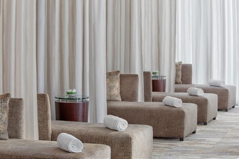 A pool table in a modern room with large windows offering a city view. at Hotel Beaux Arts, Autograph Collection