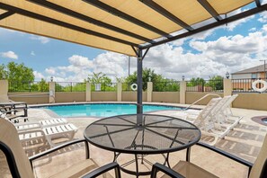 Seasonal outdoor pool, open 10:00 AM to 10:00 PM, pool umbrellas
