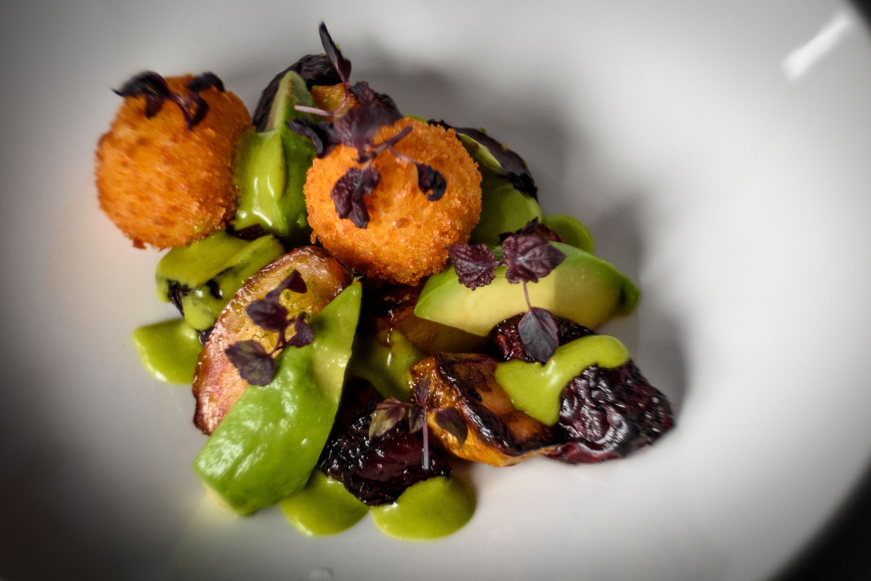 A plate of food with various vegetables and garnishes.