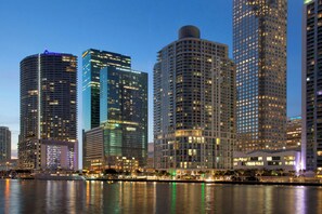 A city skyline with high-rise buildings, a waterfront, and illuminated windows. - JW Marriott Marquis Miami (Miami)